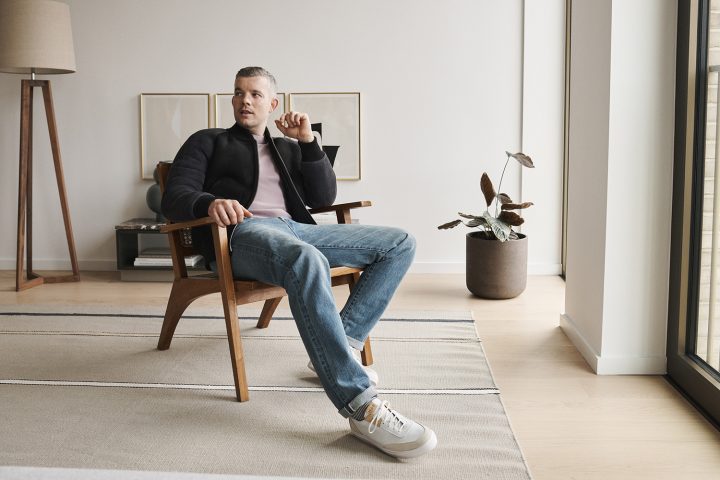 Russell Tovey photographed in London by Ben Harries for Article Magazine at Barts Square grey black shearling bomber jacket, pink cotton sweatshirt by Mr P at Mr Porter, MIB sneakers by Grenson